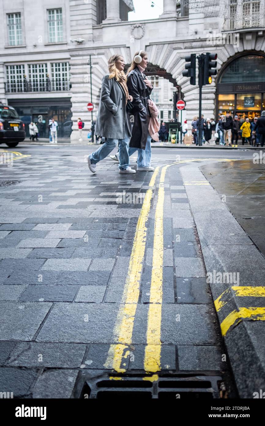 LONDON- DECEMBER 14, 2023: Shoppers on Regent Street, upmarket retail location. Stock Photo
