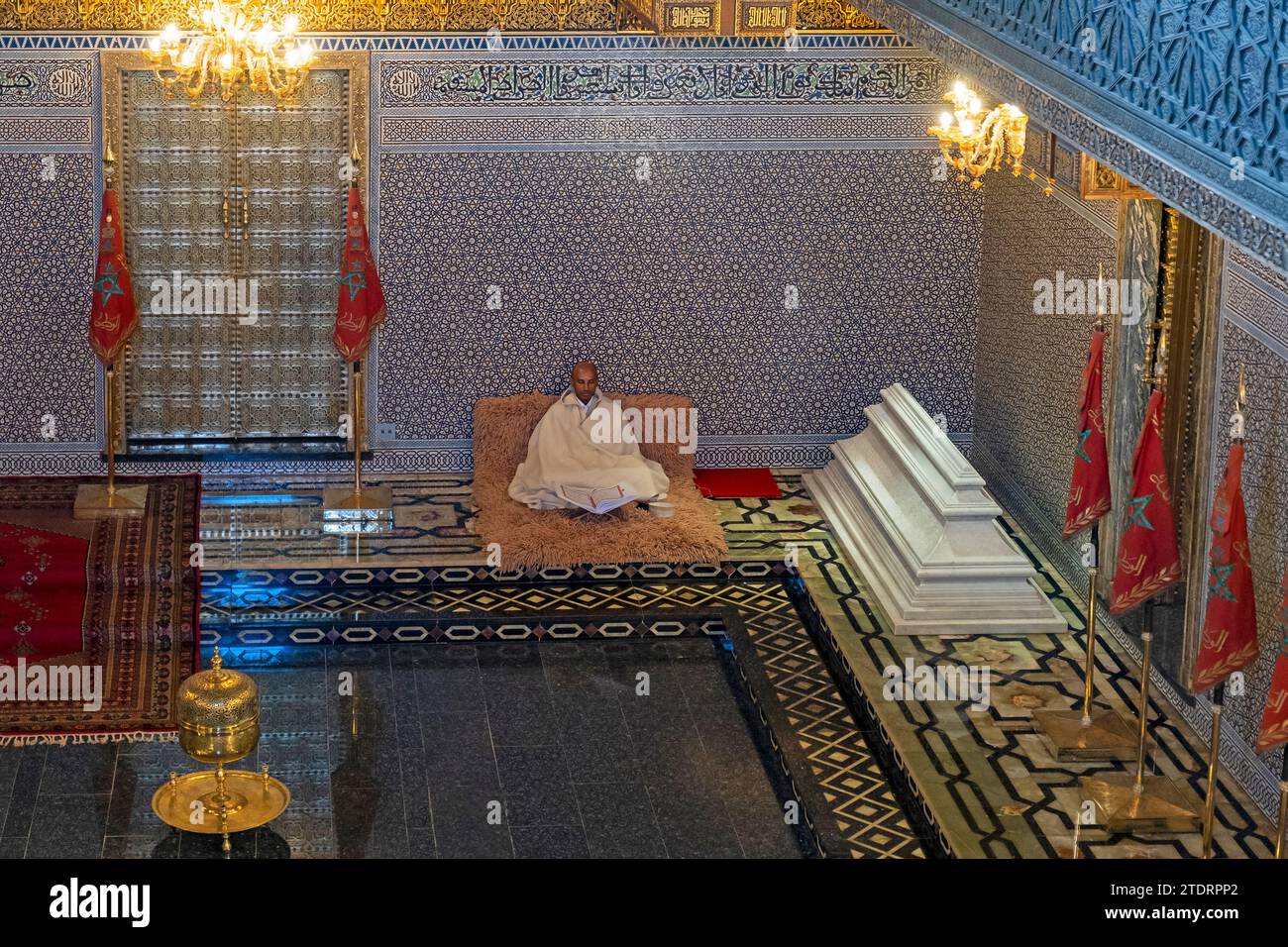 Interior of Mausoleum of Mohammed V showing reader of the Quran / Koran and tomb of his son King Hassan II in city Rabat, Rabat-Salé-Kénitra, Morocco Stock Photo