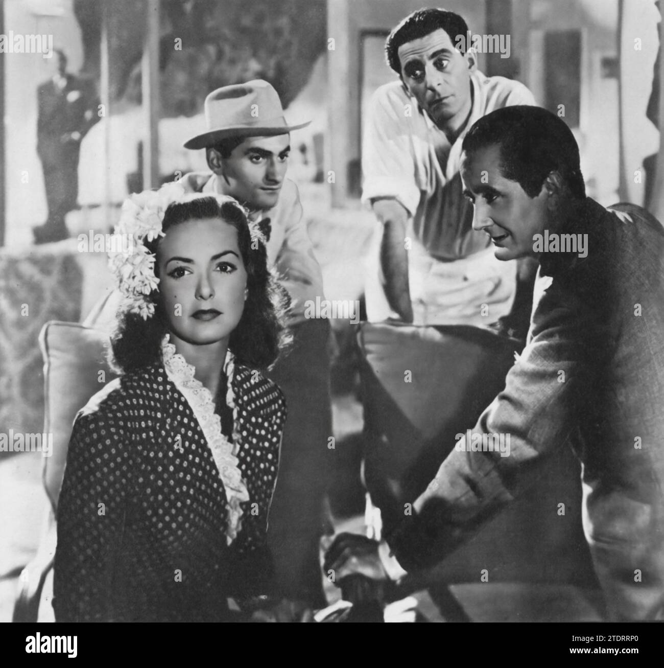 Patricia Roc, Bonar Colleano, Charles Goldner, and Nino Martini star in 'One Night with You' (1948), a musical romance. The film tells the story of an Italian singer, played by Martini, who finds himself entangled in a series of comedic mix-ups and romantic encounters in London, including with Roc's character. This charming and light-hearted film showcases the talents of its cast, blending music, humor, and romance in a delightful post-war cinematic experience. Stock Photo