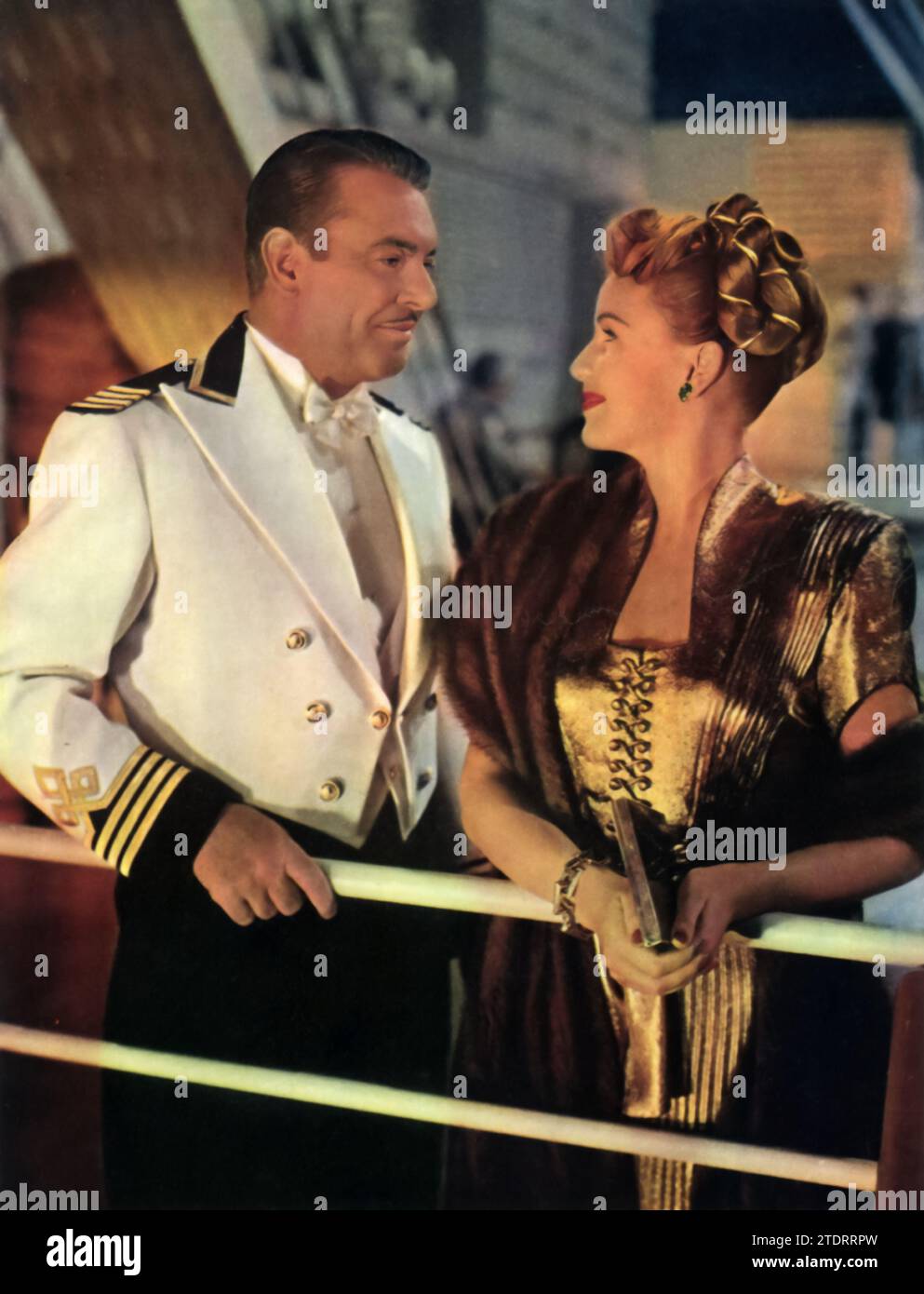 George Brent and Frances Gifford are shown in a scene from 'Luxury Liner' (1948). This musical romance film features Brent and Gifford amidst the glamorous setting of an ocean liner, where their characters' stories intertwine with music and love. Their performances, set against the backdrop of a luxury cruise, contribute to the film's blend of romance, adventure, and captivating musical numbers. Stock Photo