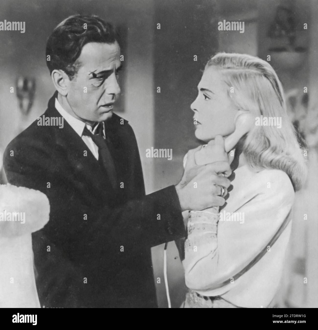 Humphrey Bogart and Lizabeth Scott star in the film noir 'Dead Reckoning' (1947). In this gripping thriller, Bogart plays a war veteran who delves into the criminal underworld to uncover the truth behind his friend's mysterious death. Scott portrays a femme fatale, adding intrigue and complexity to the plot. The film is known for its dark atmosphere, sharp dialogue, and the strong chemistry between Bogart and Scott, making 'Dead Reckoning' a classic example of the film noir genre. Stock Photo