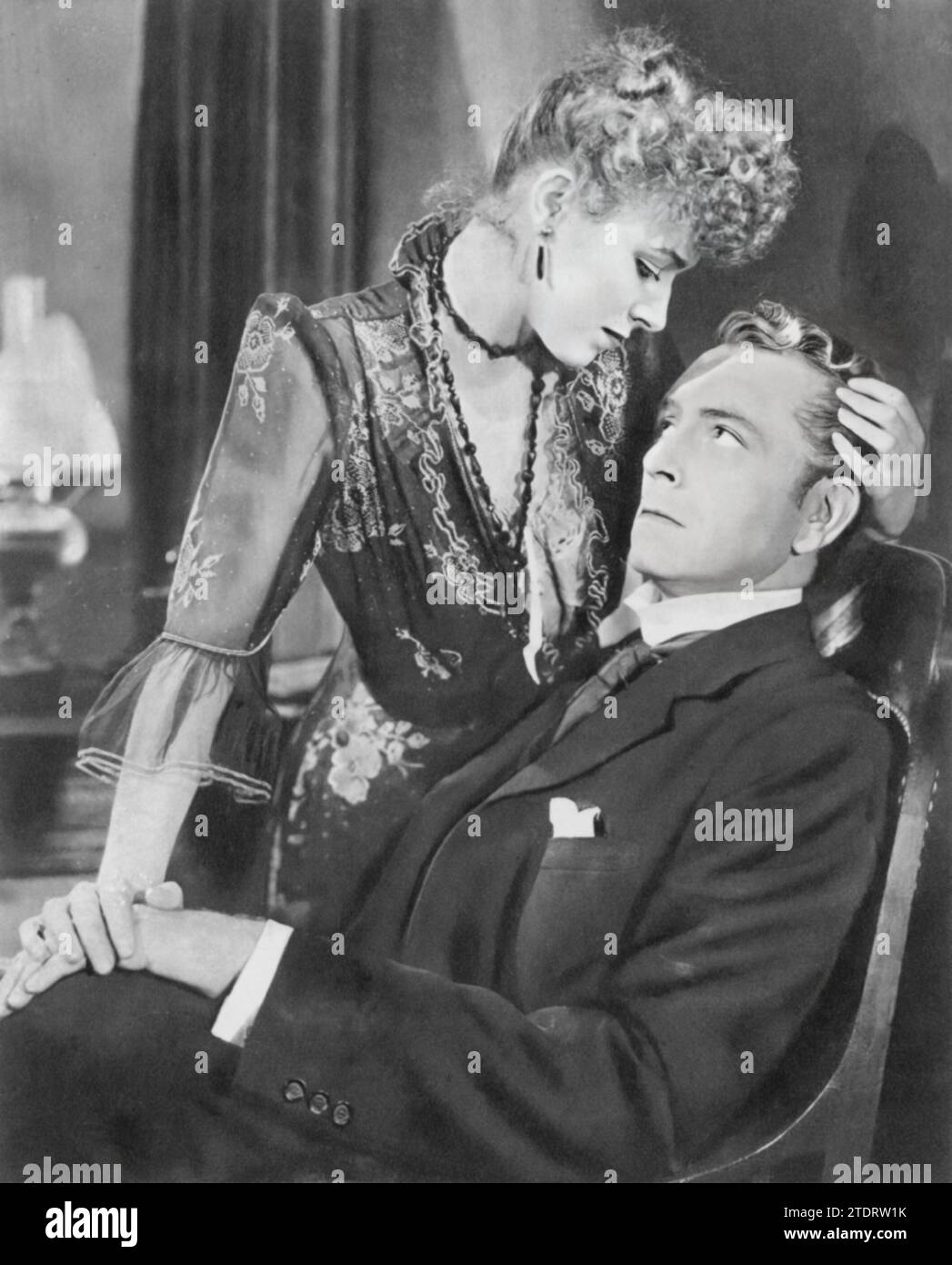 Eleanor Parker and Paul Henreid star in the film adaptation of W. Somerset Maugham's novel 'Of Human Bondage' (1946). In this drama, Henreid plays medical student Philip Carey, who becomes obsessively in love with Mildred Rogers, a manipulative waitress portrayed by Parker. The film delves into the complexities of unrequited love, obsession, and self-destruction. Stock Photo
