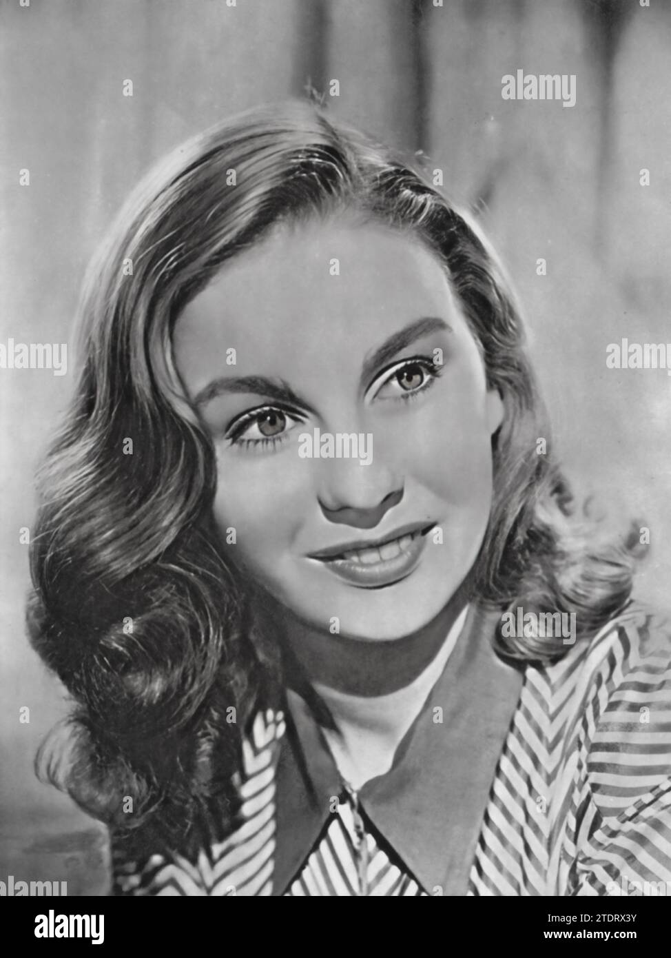 Jean Simmons, born on January 31, 1929, and died January 22, 2010, was a distinguished British actress known for her roles in various classic films. She gained notable recognition for her performance in 'The Way to the Stars' (1945), a British war film. Simmons' portrayal in this and other films of the era showcased her versatility and depth as an actress, earning her acclaim in both British and later in Hollywood cinema. Her career spanned several decades, during which she delivered a series of memorable performances that solidified her status as a prominent figure in the film industry. Stock Photo