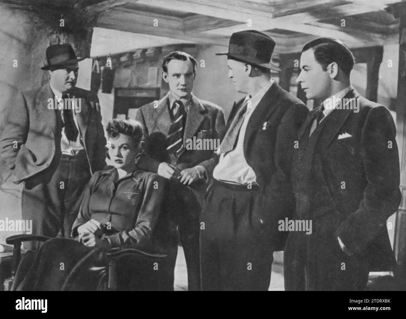 George Woodbridge, Alastair Sim, Rosamund John, Trevor Howard, and Leo Genn come together in the classic British thriller 'Green for Danger' (1946). Set in a wartime hospital, the film is a masterful blend of suspense and dark humor. Alastair Sim, in a standout performance, plays the astute Inspector Cockrill, who investigates mysterious deaths at the hospital. The ensemble cast, including John, Howard, and Genn, adds to the intrigue and complexity of the plot, making 'Green for Danger' a memorable and engaging mystery film. Stock Photo