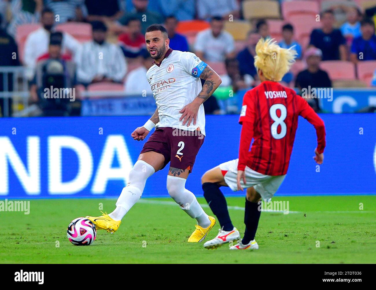 Manchester City's Kyle Walker (left) and Urawa Red Diamonds' Yoshio Koizumi battle for the ball during the FIFA World Cup Club Saudi Arabia 2023 semi-final match at the King Abdullah Sports City Stadium, Jeddah. Picture date: Tuesday December 19, 2023. Stock Photo