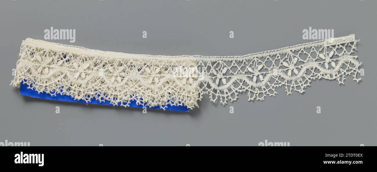 Strip of bobbin lace with a cross of four leaves, Strip of natural-colored  bobbin lace, lace. The strip is short, only a part of the pattern is  visible. Made in a sort