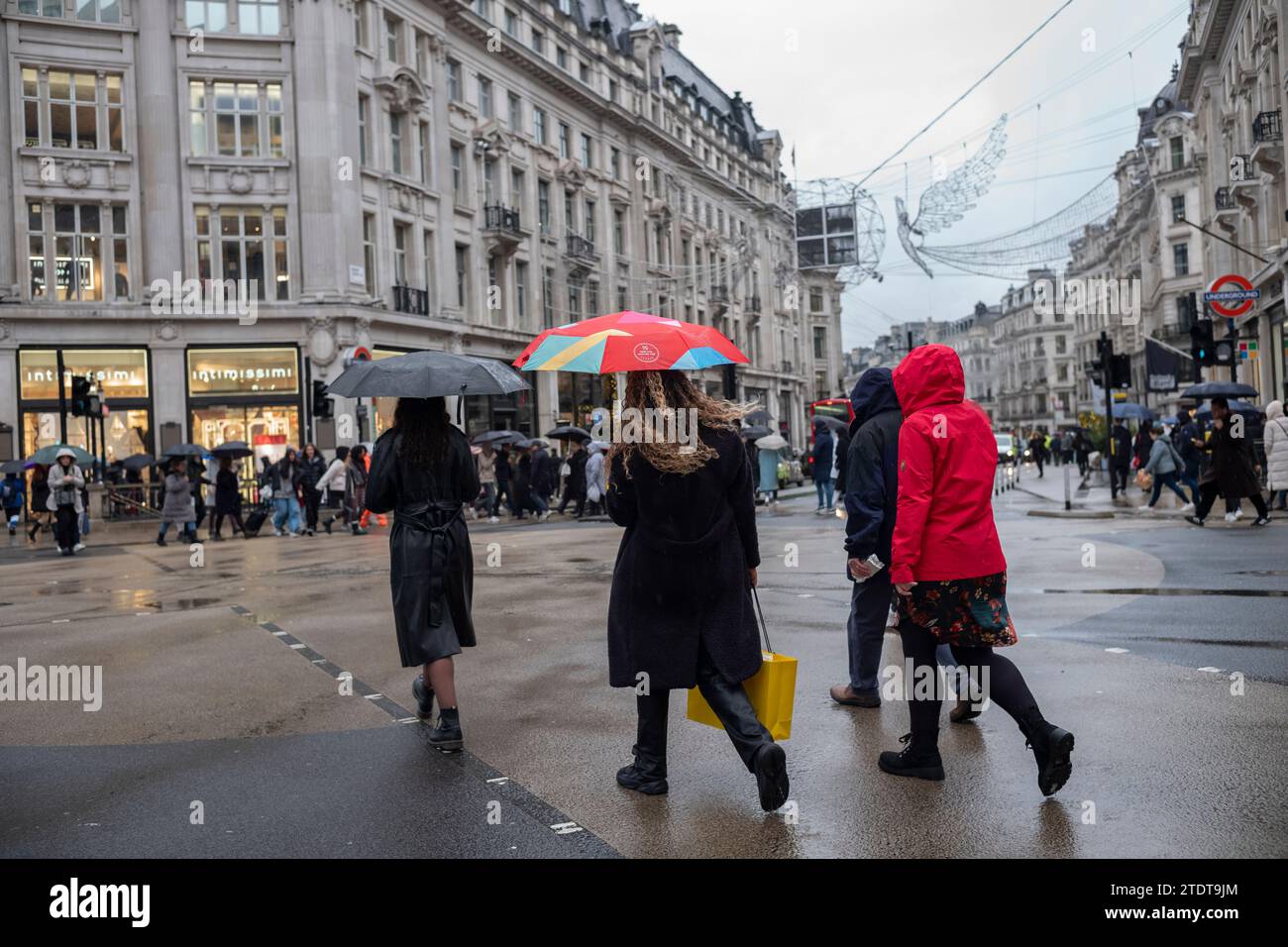 Christmas shoppers in Oxford Circus on a wet winters day, London, England, United Kingdom Stock Photo