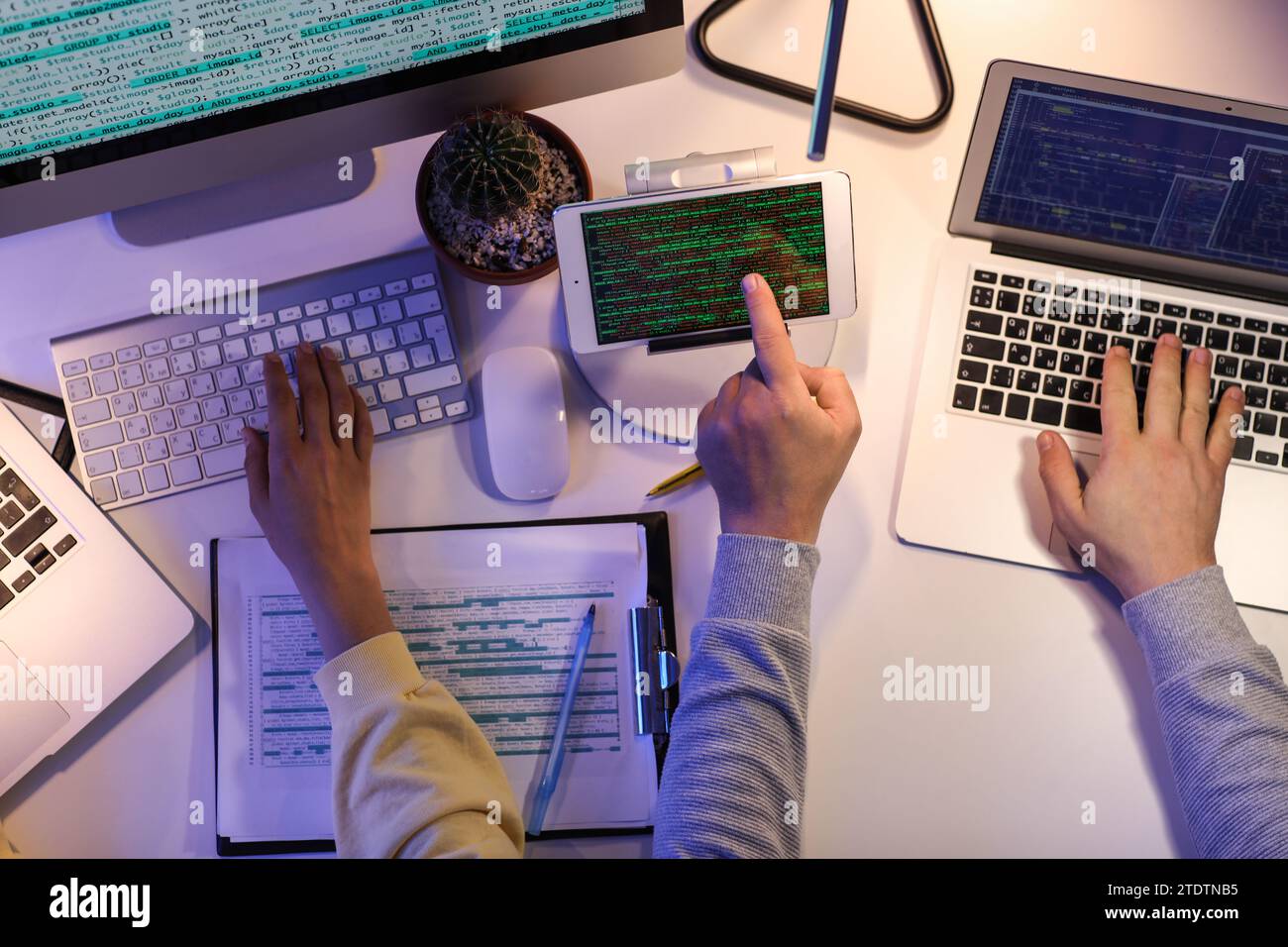 Programmers working in office at night, top view Stock Photo