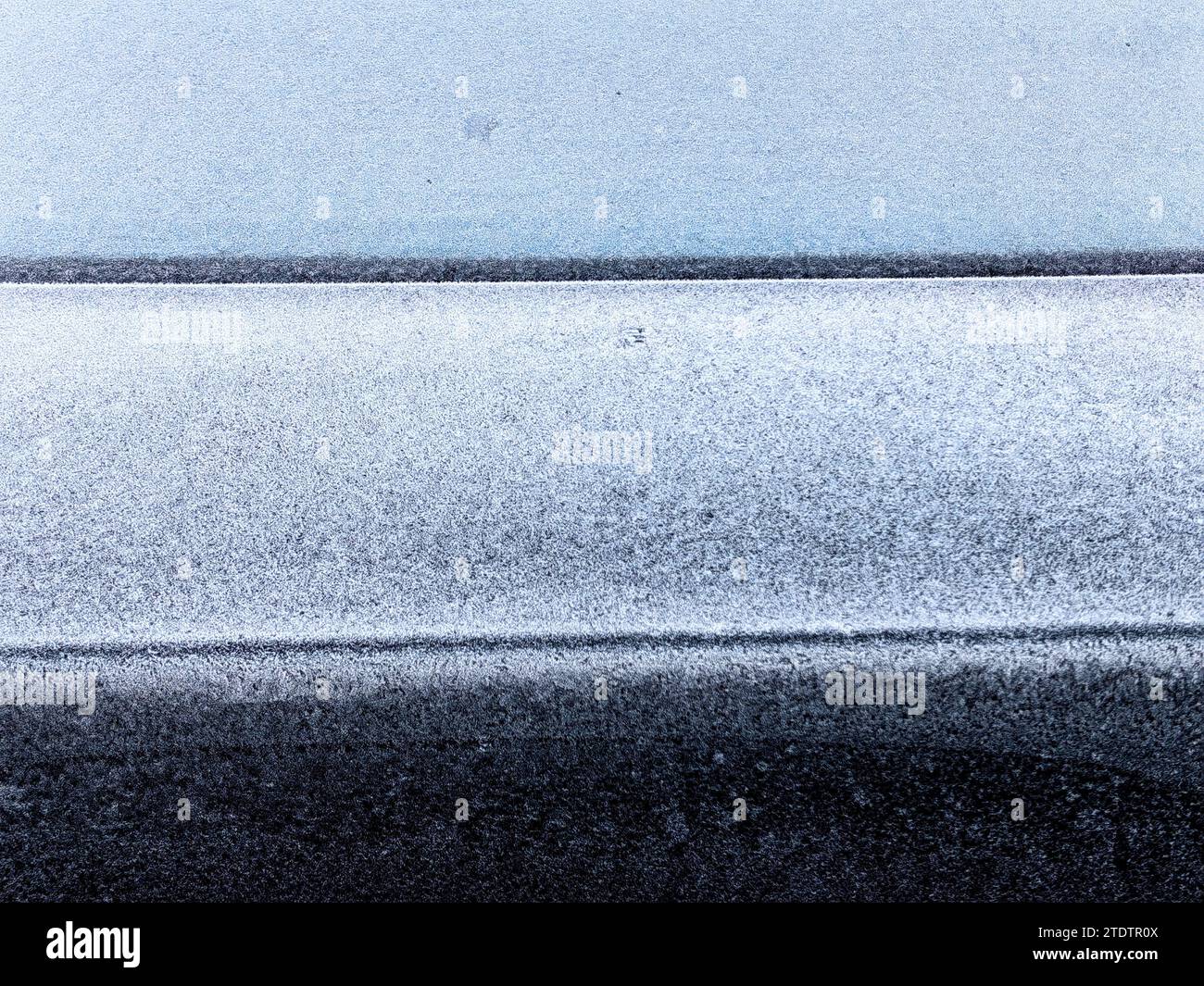 Frozen back window . Background. Layers. Trunk, part of the car. White , gray and black colors. Stock Photo