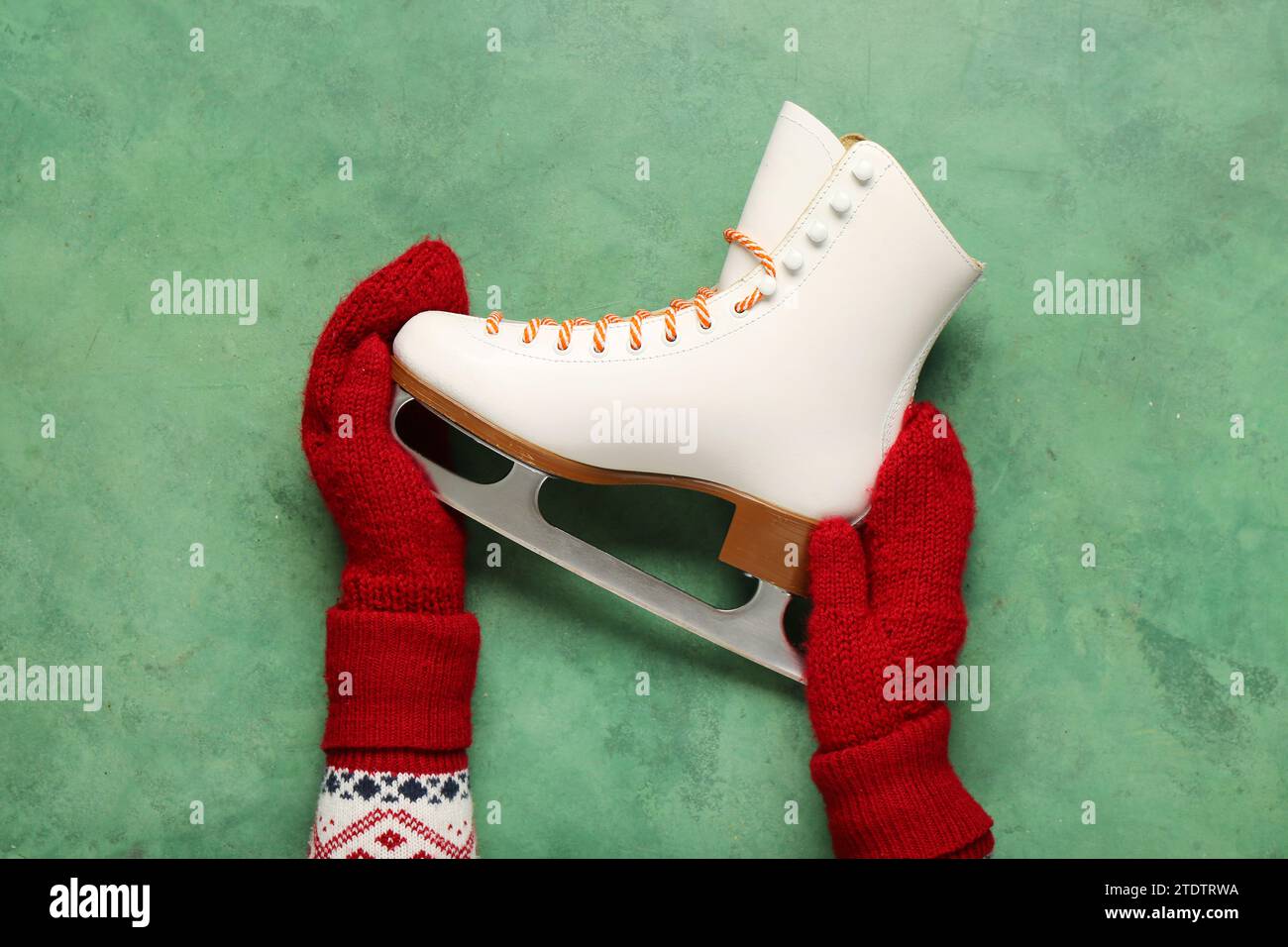 Female Hands With Ice Skate On Green Background Stock Photo Alamy