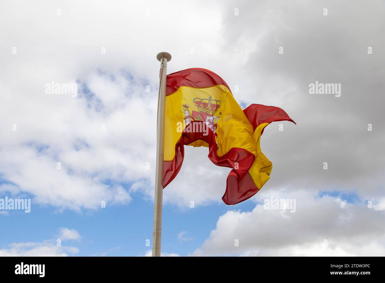 The bright sun illuminates the red and yellow stripes of the flag, creating a vibrant contrast