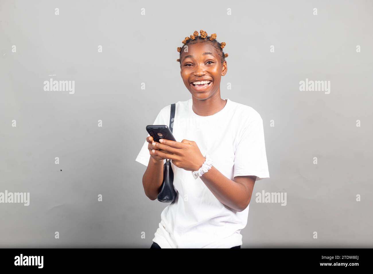 beautiful african woman smiling while using her mobile phone Stock ...