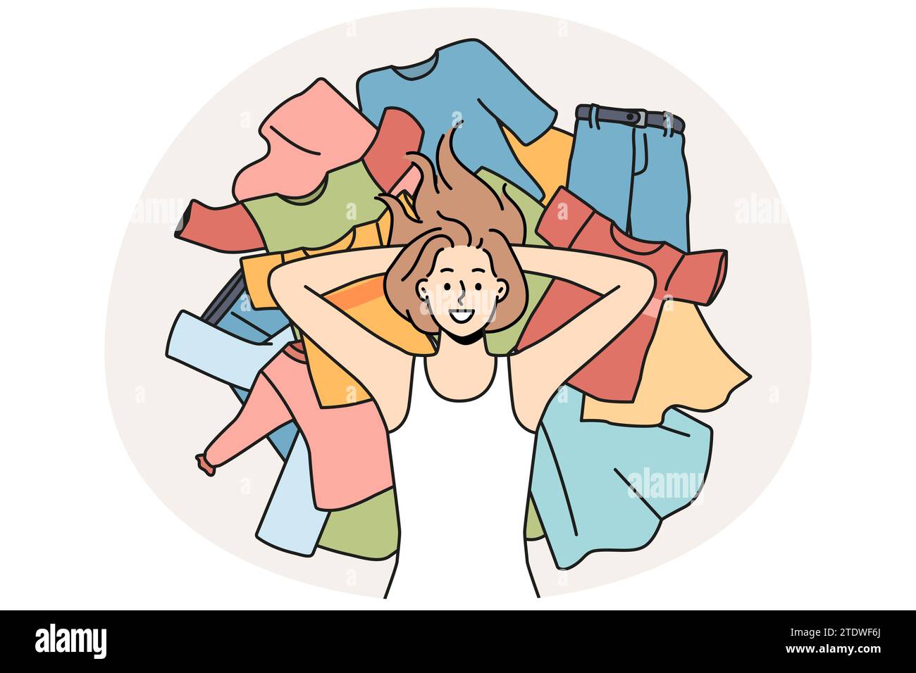 Smiling young woman lying on pile of clothes. Happy girl on stock of ...