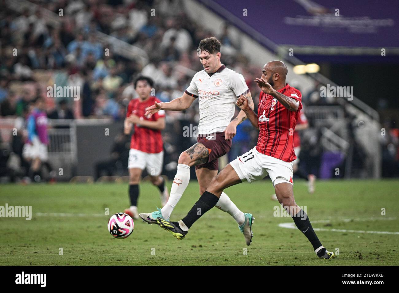 Jeddah, Saudi Arabia. 19th Dec, 2023. King Abdullah Sports City John Stones of Manchester City and Jose Kante of Urawa Reds during the FIFA Club World Cup Semi Final between Urawa Reds of Japan and Manchester City of England at the King Abdullah Sports City Stadium in Jeddah, Saudi Arabia. City won the game 3-0 and will play Fluminense of Brazil in the final on Friday. (Alexandre Neto/SPP) Credit: SPP Sport Press Photo. /Alamy Live News Stock Photo