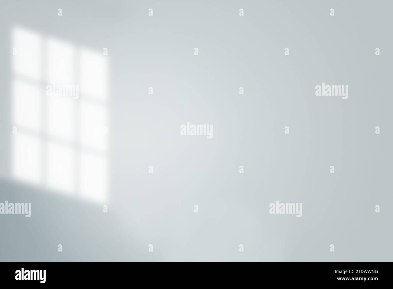 Illuminated lines: a play of sunlight and shadows falling from a window onto a light wall. Stock Photo