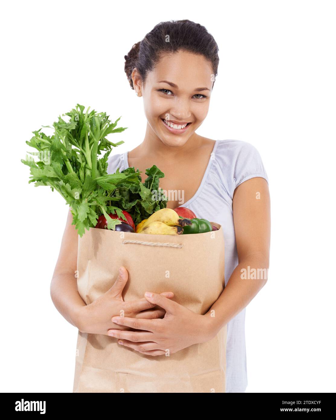 Vegetables, shopping portrait and happy woman in studio for healthy food, sustainability or diet. Young person, customer or model with bag of Stock Photo