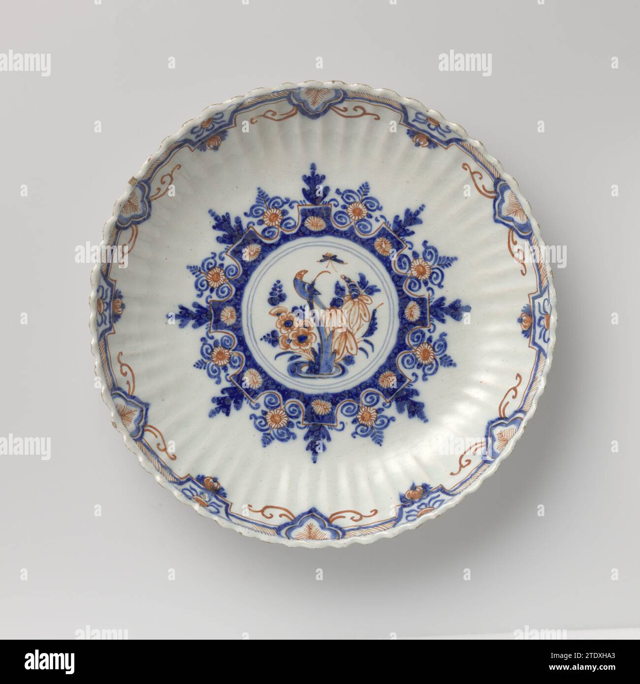 Dish of multicolored painted Faïence, the double gift jug, c. 1700 - c. 1730 Dish of Faience. Rouaan for example. Multicolored painted. The dish is marked. Delft . Dish of Faience. Rouaan for example. Multicolored painted. The dish is marked. Delft . Stock Photo