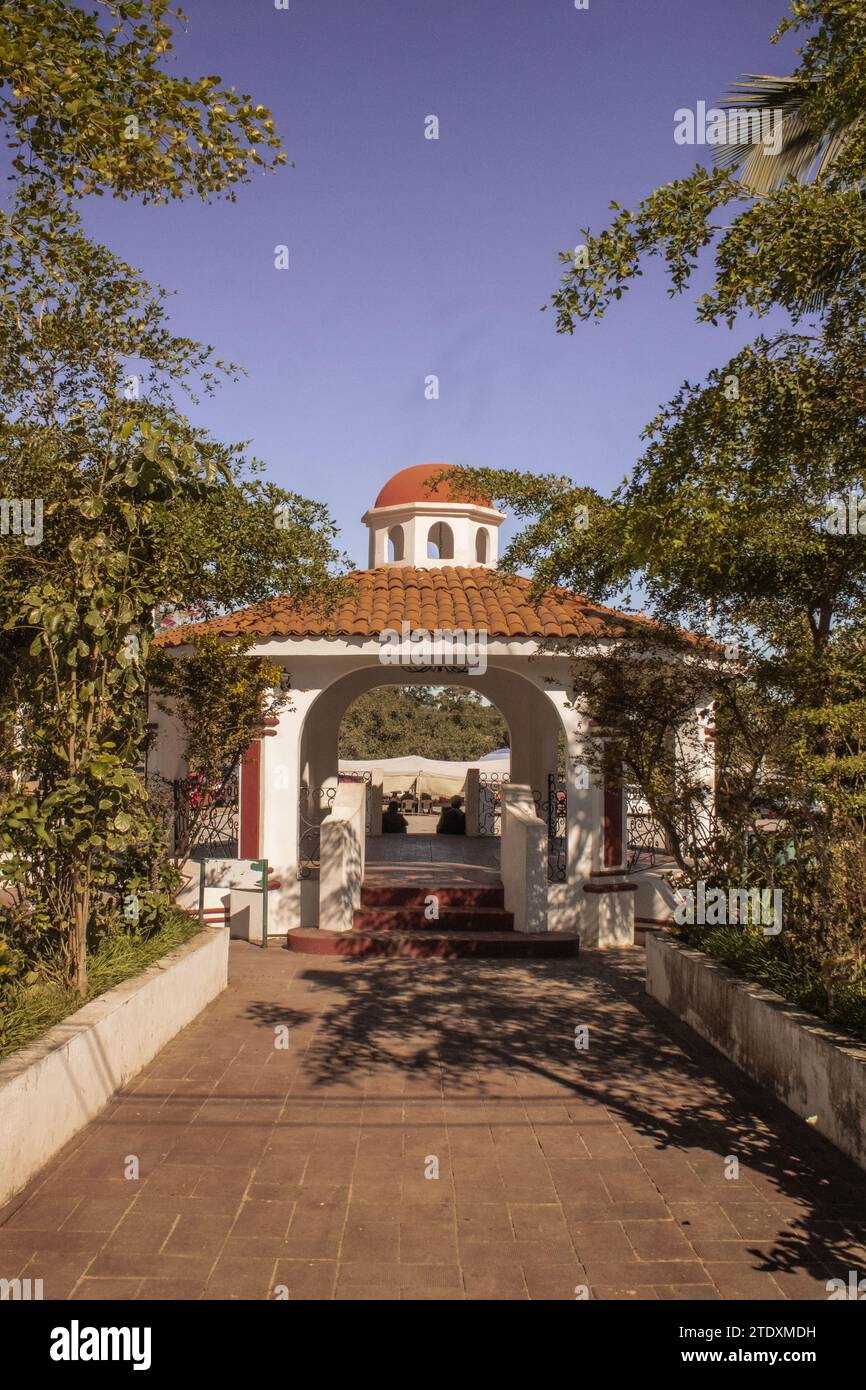Traditional Mexican charm in Nayarit, architectural beauty with graceful arches amidst lush, tropical greenery. Stock Photo