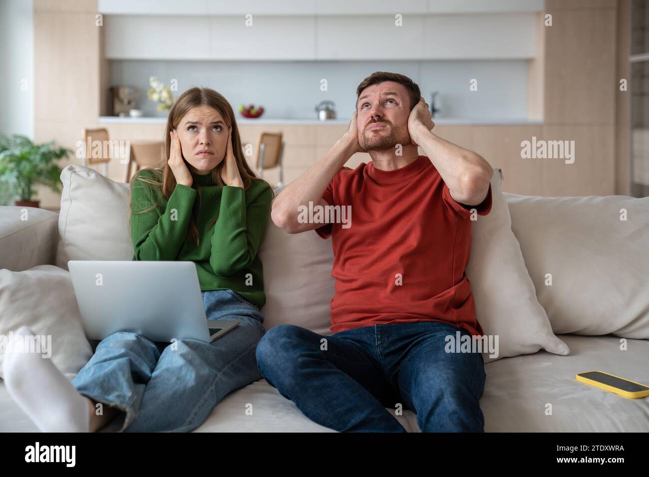 Stressed unhappy couple suffering from noisy neighbor. Disadvantages of