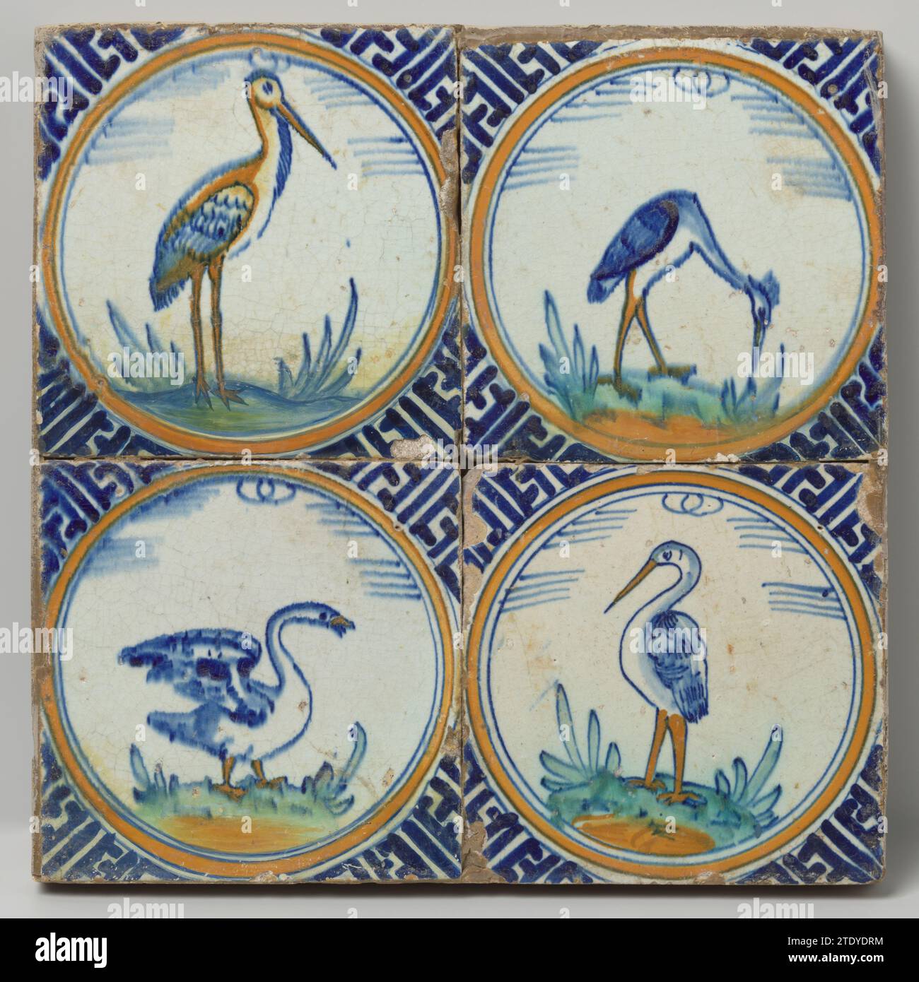 Field of four tiles with birds, anonymous, c. 1620 - c. 1640 Field of four tiles (2 x 2) each with a multicolored (blue, orange, green, yellow and purple) bird inside a circle on a floor. In the corners, meander ornament. Netherlands earthenware. tin glaze majolica Field of four tiles (2 x 2) each with a multicolored (blue, orange, green, yellow and purple) bird inside a circle on a floor. In the corners, meander ornament. Netherlands earthenware. tin glaze majolica Stock Photo