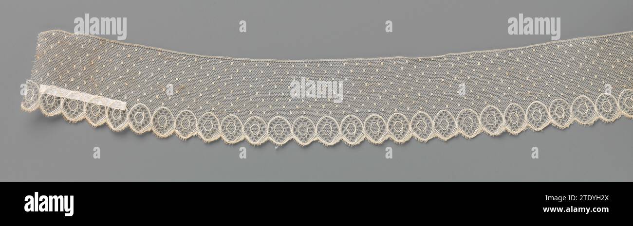 Strip bobbin with a spray pattern of moesjes and connected ovals along ...