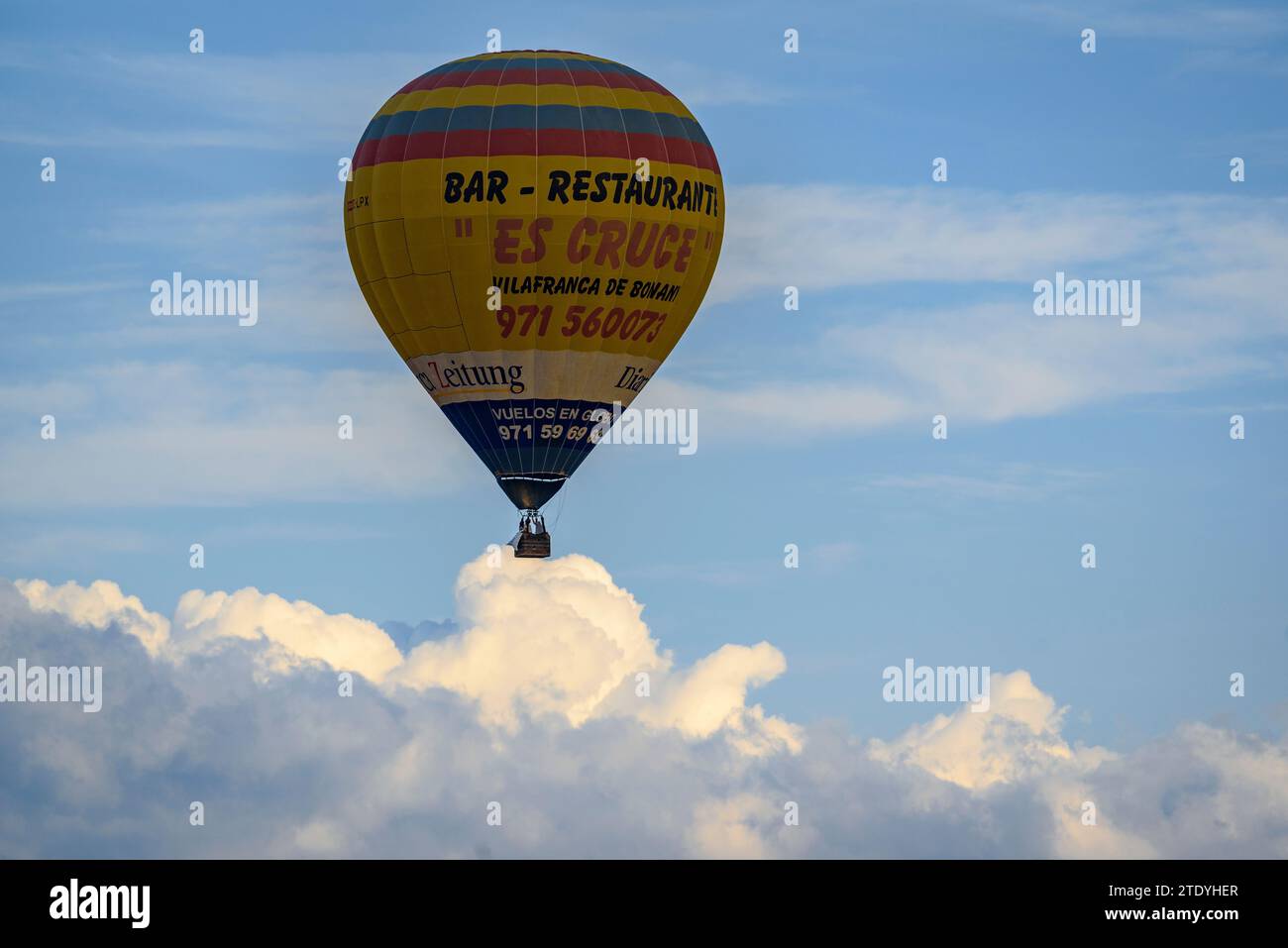 Hot air balloon flying over the sky of Mallorca on a spring morning (Mallorca, Balearic Islands, Spain) ESP: Globo aerostático sobrevolando Mallorca Stock Photo
