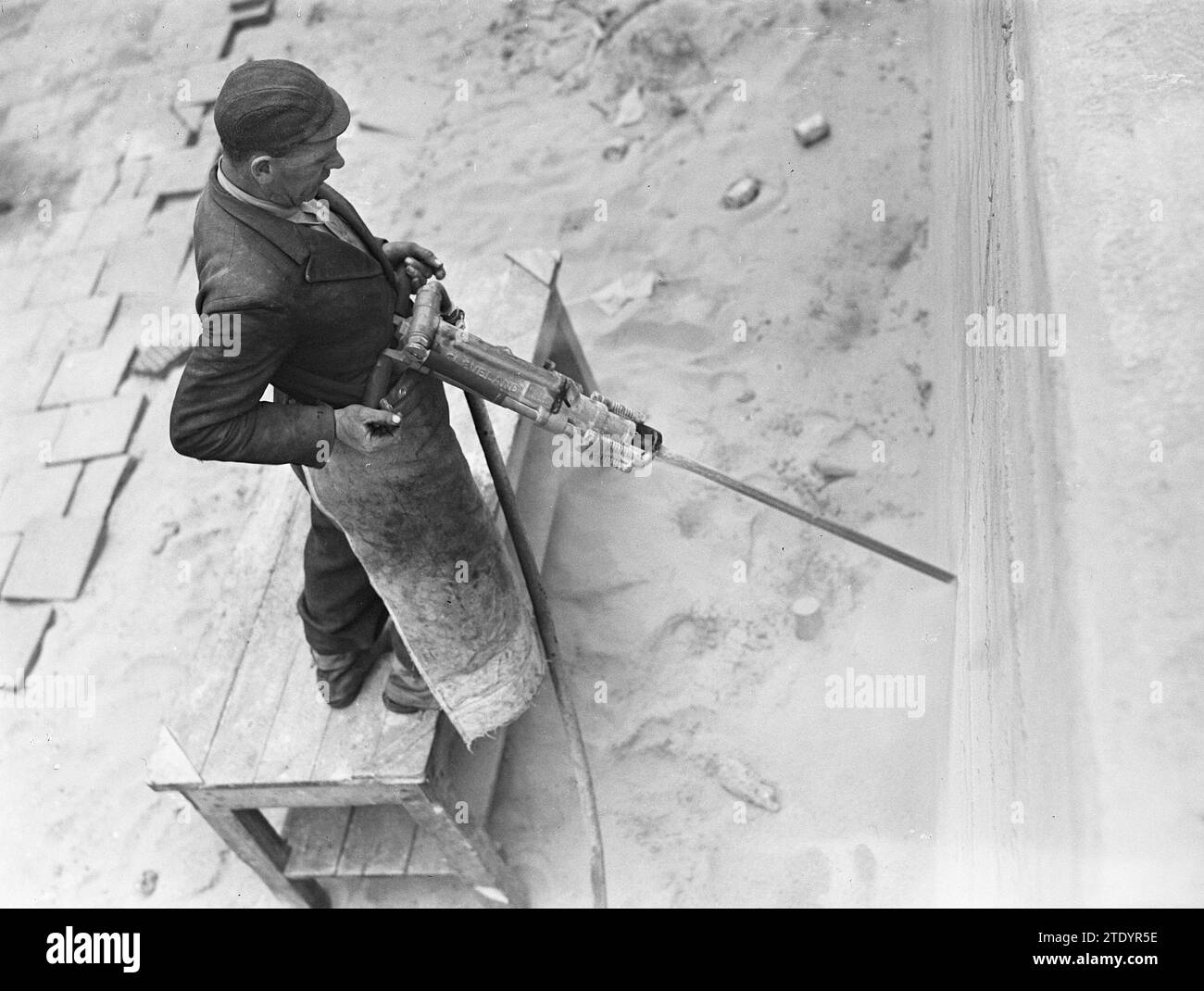 Scheveningen, the demolition of the bunkers and barriers, man using a