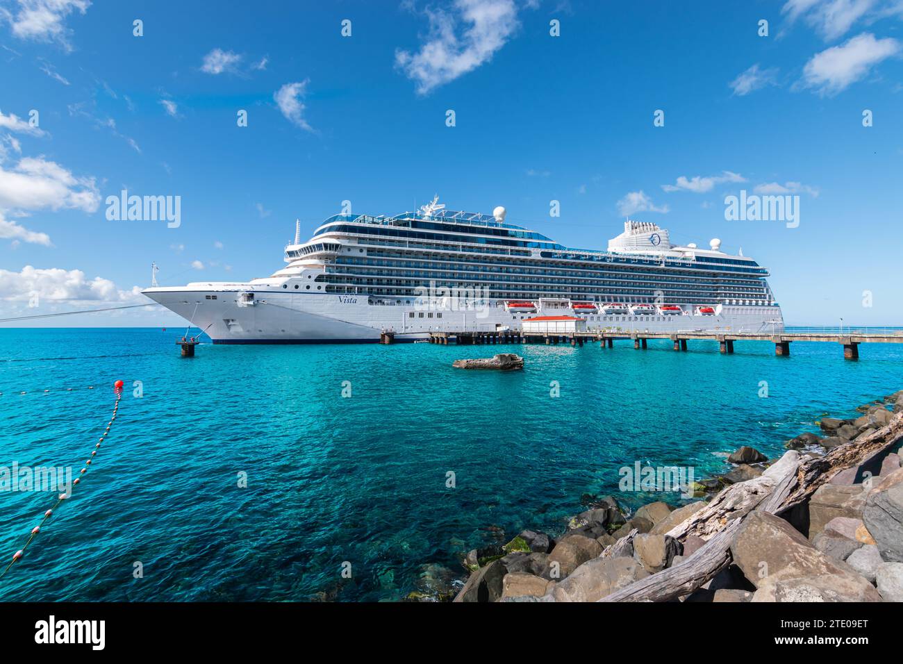 Roseau, Dominica - November 24, 2023: Side view of beautiful cruise ship Oceania Cruises Vista in port of Roseau, Dominica. Stock Photo
