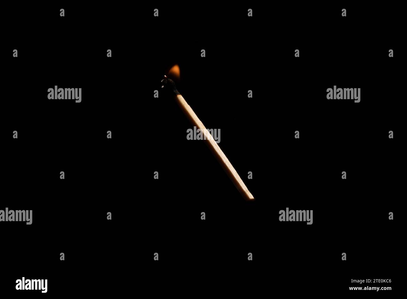 Lit and falling match on a black background. Stock Photo