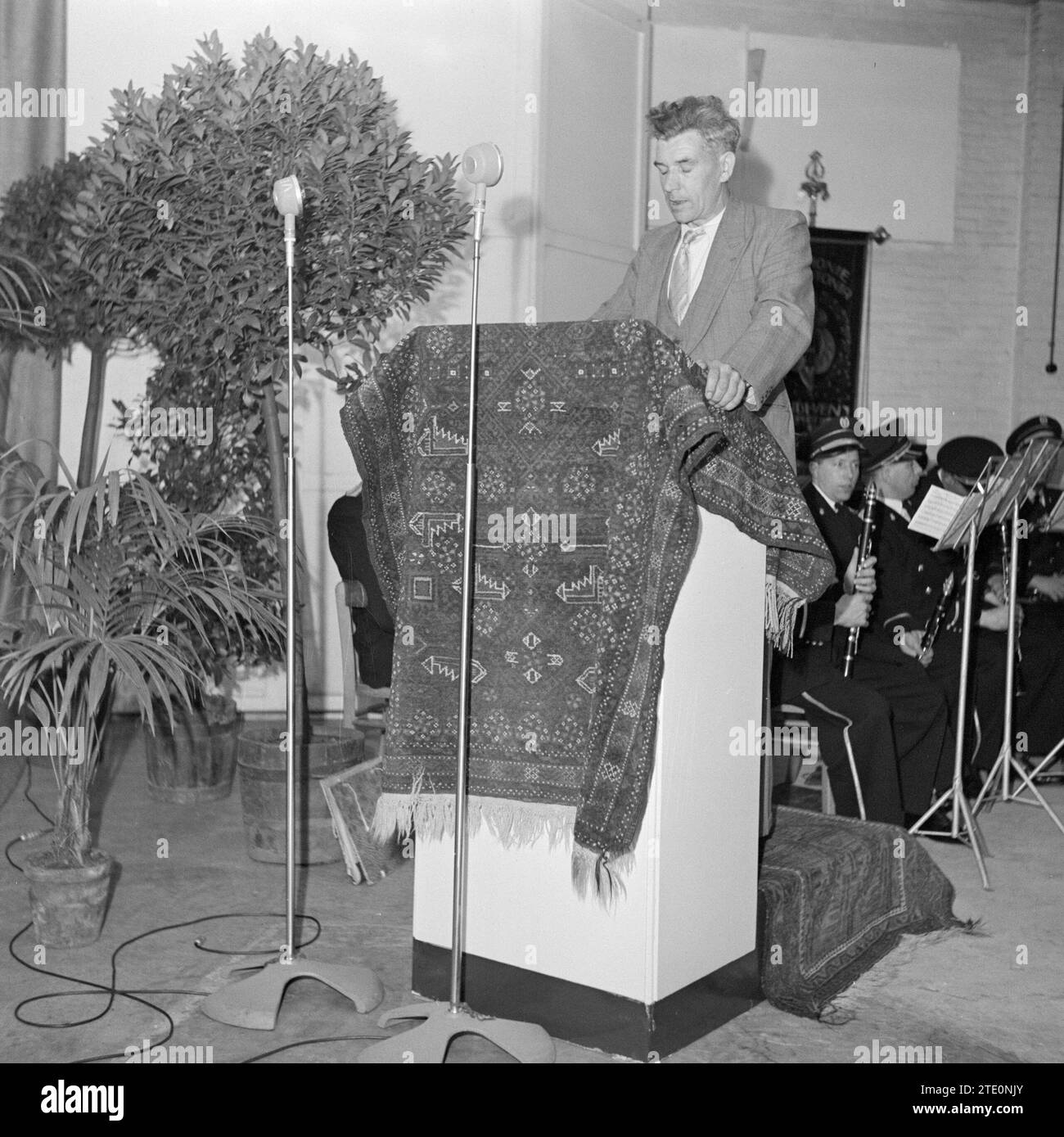 Man standing behind a carpeted lectern ca. 1950 Stock Photo