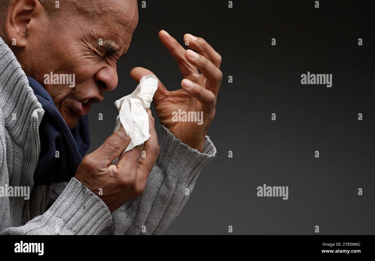 man catching the cold and flu man blowing nose after catching a cold