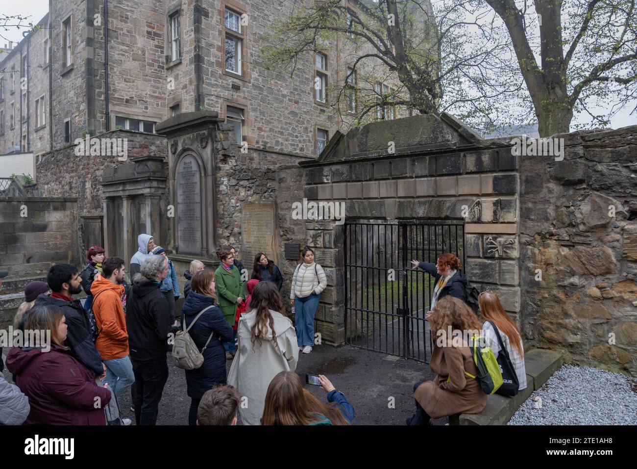 Group of tourists with a guide at Covenanters' Prison gate in the Greyfriars Kirkyard in city of Edinburgh, Scotland, UK. Covenanters' Prison Known as Stock Photo