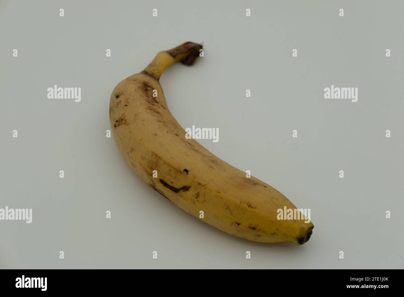 Banana starting to rot on a white background Stock Photo Alamy