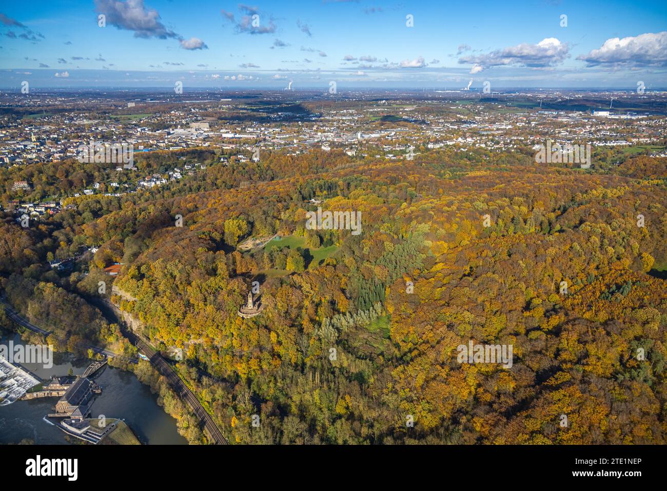 Aerial view, local recreation area Hohenstein, waterworks Hohenstein at the river Ruhr and the mountain monument in the autumnal forest in bright autu Stock Photo