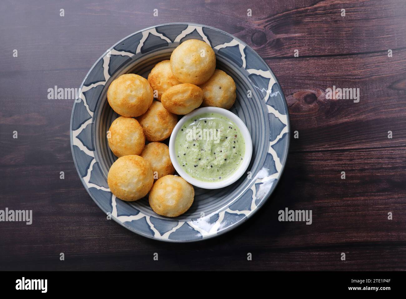 Paniyaram are savory balls made using fermented rice and urad dal batter along with tempered onion and spices. Also known as Paddu, appe. Stock Photo