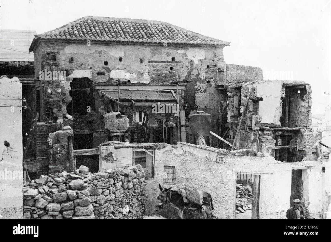 04/30/1935. Alcazaba of Malaga. To discover some arches, it has been necessary to demolish partitions and floors of previously expropriated homes. Photo: Aguilera.-la alcazaba It is one of the most significant buildings in Malaga. It is a building from the Islamic period built on a small hill at the eastern end of the city. According to Arab Sources, it was built by Badis, King Ziri of Granada, between 1057 and 1063, although it is possible that an earlier building was erected in that same place. The work was made with ashlars of Nummulite Limestone, extracted from quarries close to the sea. T Stock Photo