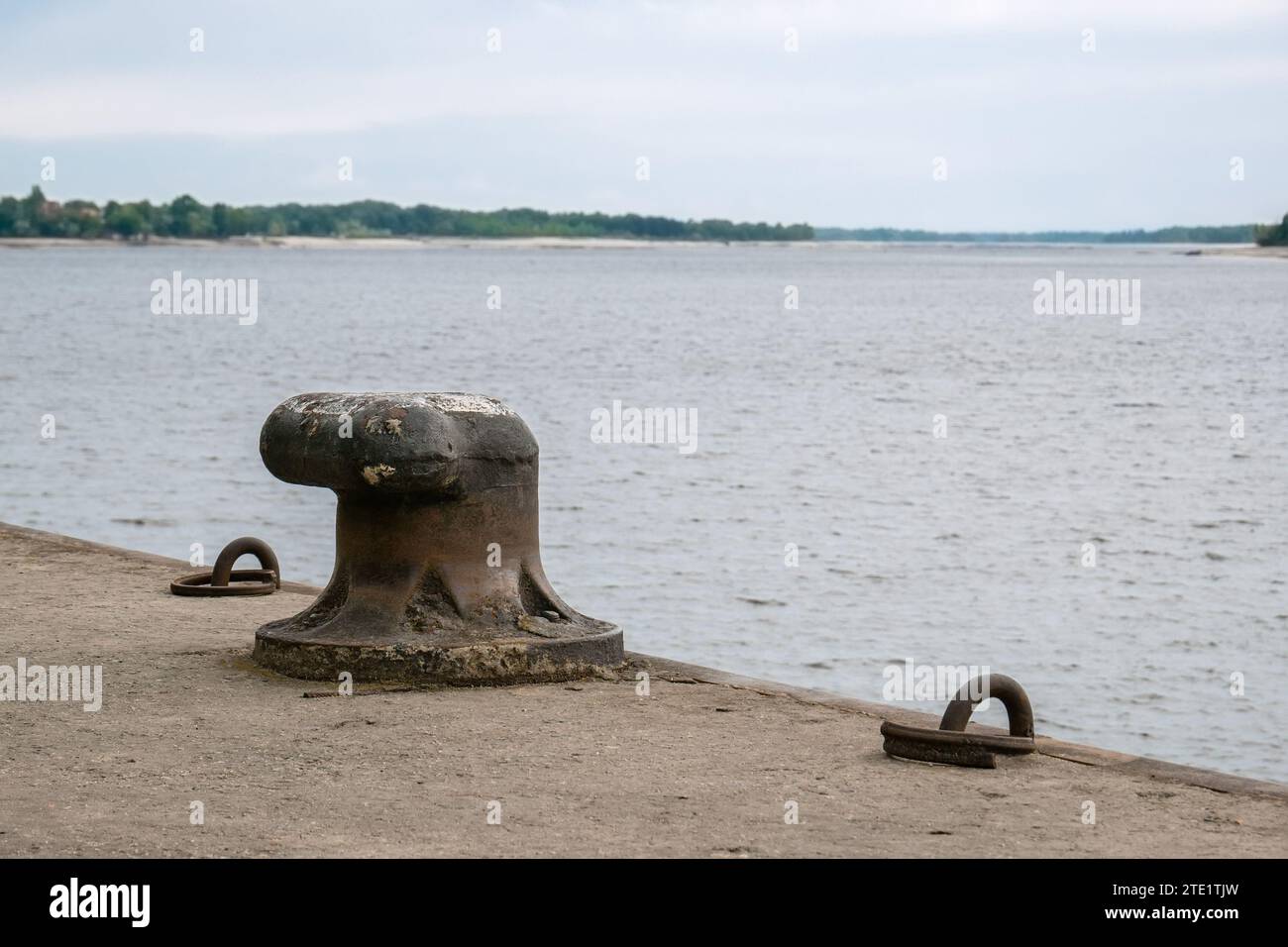 Old cast-iron bollard on the pier of the river pier Stock Photo