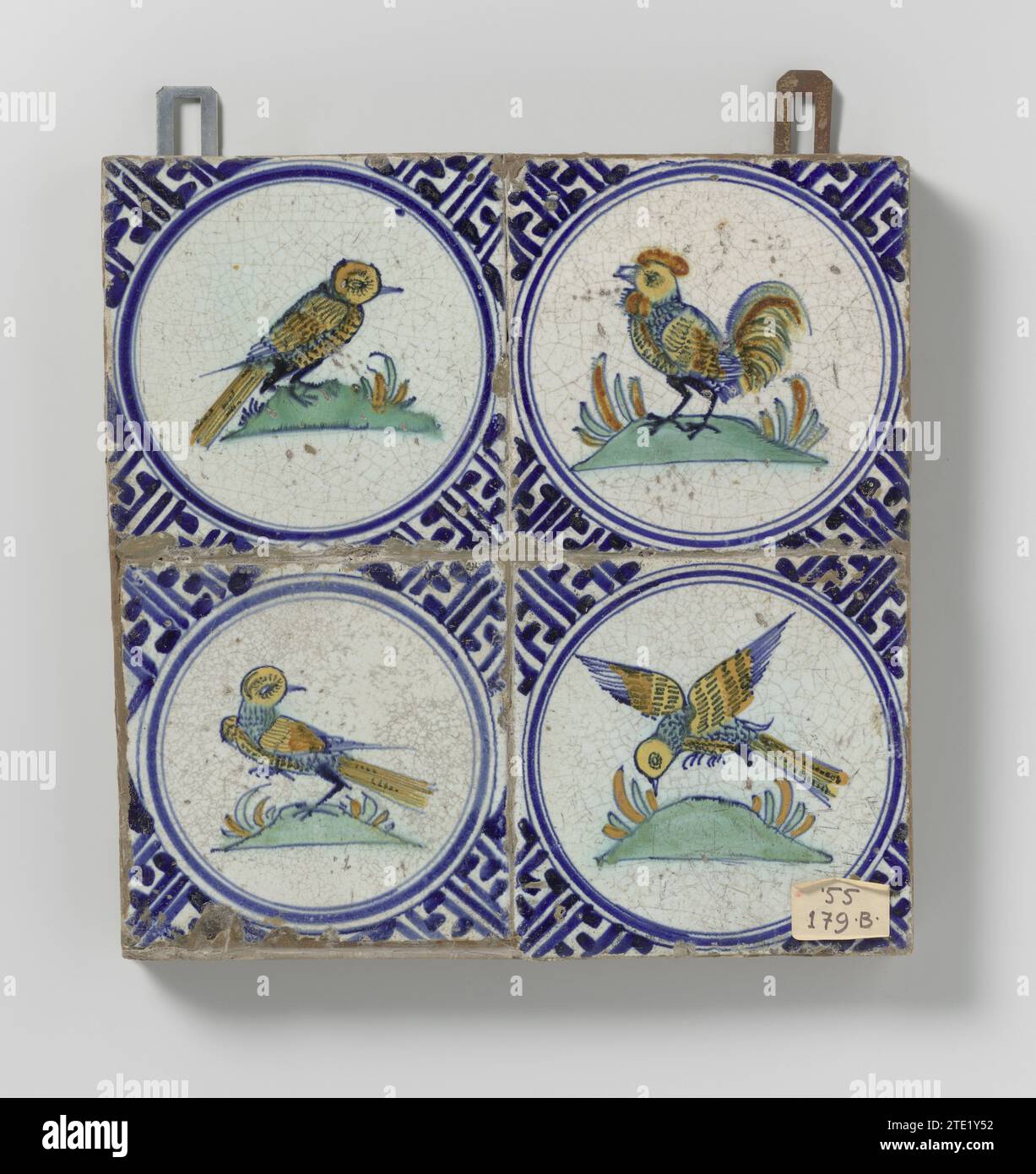 Field of four tiles with birds, anonymous, c. 1620 - c. 1640 Field of four tiles (2 x 2) each with a multicolored (blue, orange, green, yellow and purple) bird inside a circle on a floor. In the corners, meander ornament. Netherlands earthenware. tin glaze majolica Field of four tiles (2 x 2) each with a multicolored (blue, orange, green, yellow and purple) bird inside a circle on a floor. In the corners, meander ornament. Netherlands earthenware. tin glaze majolica Stock Photo