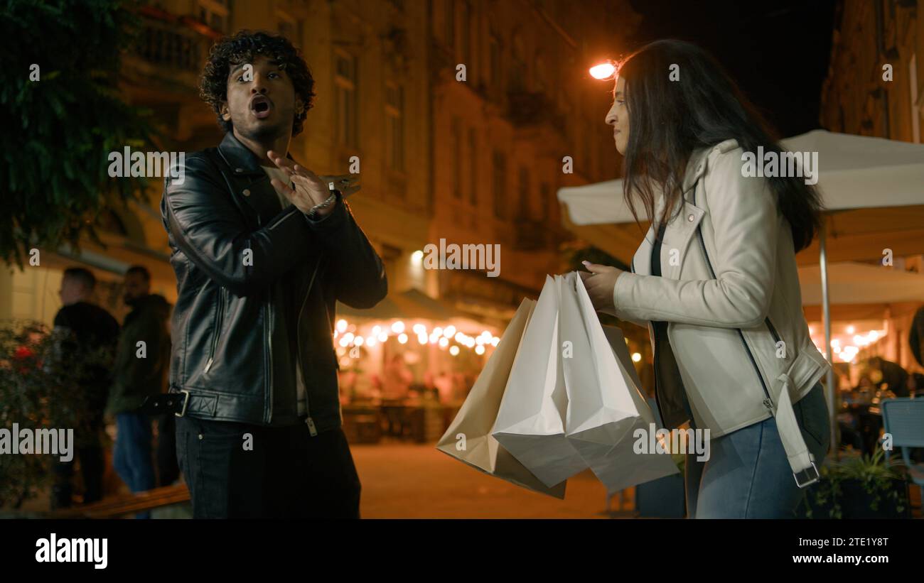 Indian married couple quarreling in evening night city about shopping
