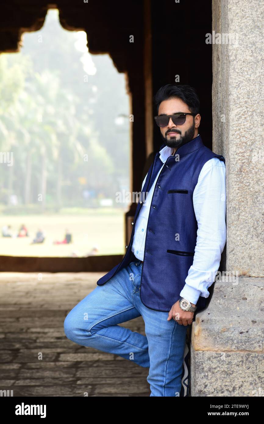 Trendy Young Indian Male Poses Confidently in Stylish Black Sunglasses. Modern Street Style, Ethnic Diversity, Cultural Identity, Handsome Model Stock Photo
