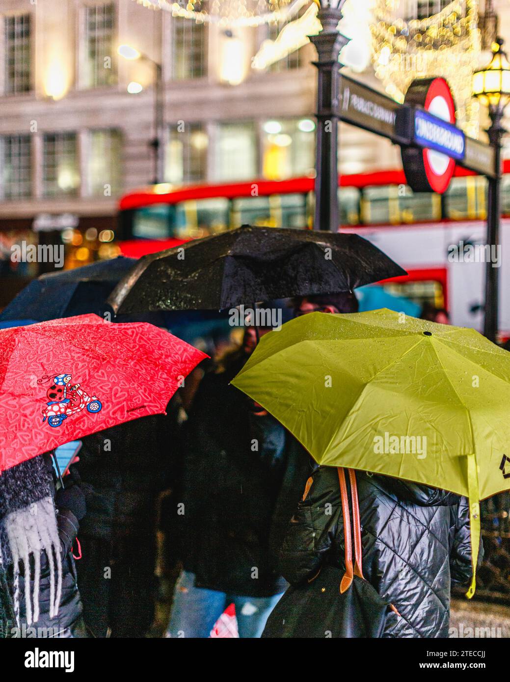 Londoners and tourist protect themselves from the rain in central London. Stock Photo