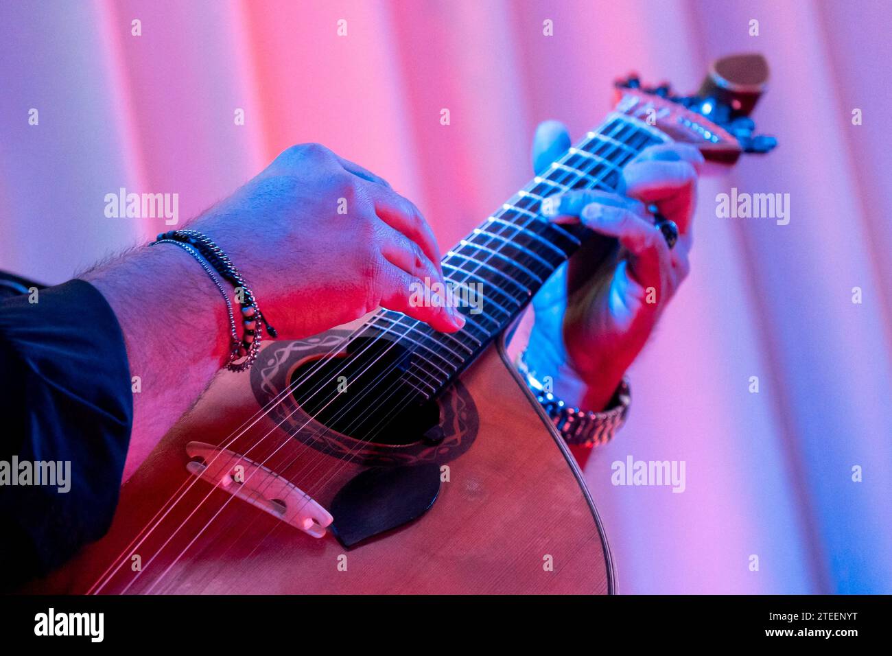 Passionate Portuguese guitarist performing soulful Fado tunes on a mesmerizing night. Stock Photo