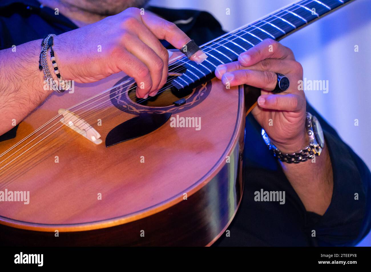 Passionate Portuguese guitarist performing soulful Fado tunes on a mesmerizing night. Stock Photo