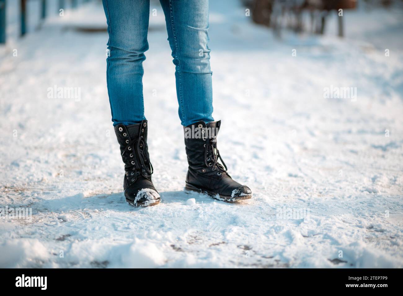 Foot In Boot Female's feet in close-up, wearing boots with anti-slip protectors ...