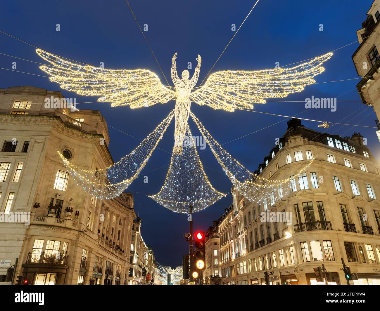Close-up view looking up at the festive Christmas Angel decorations at night in Regent Street London 2023 Stock Photo