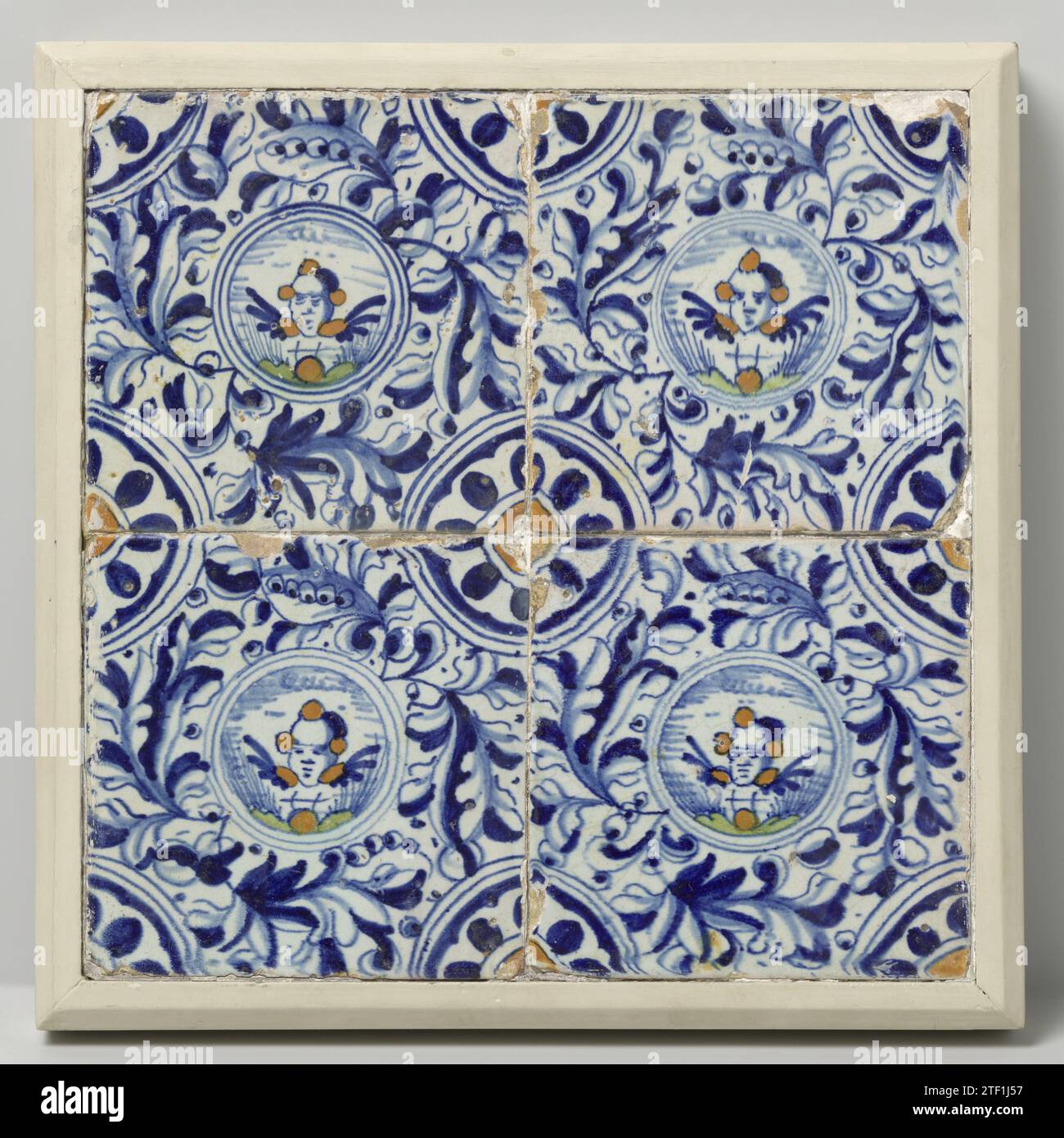 Field of four tiles, Anonymous, 1615 - 1625 Field of 4 tiles (2 x 2) each with a blue painted cherub head inside a circle with praise. In the corners, a quarter rosette. Netherlands earthenware. tin glaze majolica Field of 4 tiles (2 x 2) each with a blue painted cherub head inside a circle with praise. In the corners, a quarter rosette. Netherlands earthenware. tin glaze majolica Stock Photo