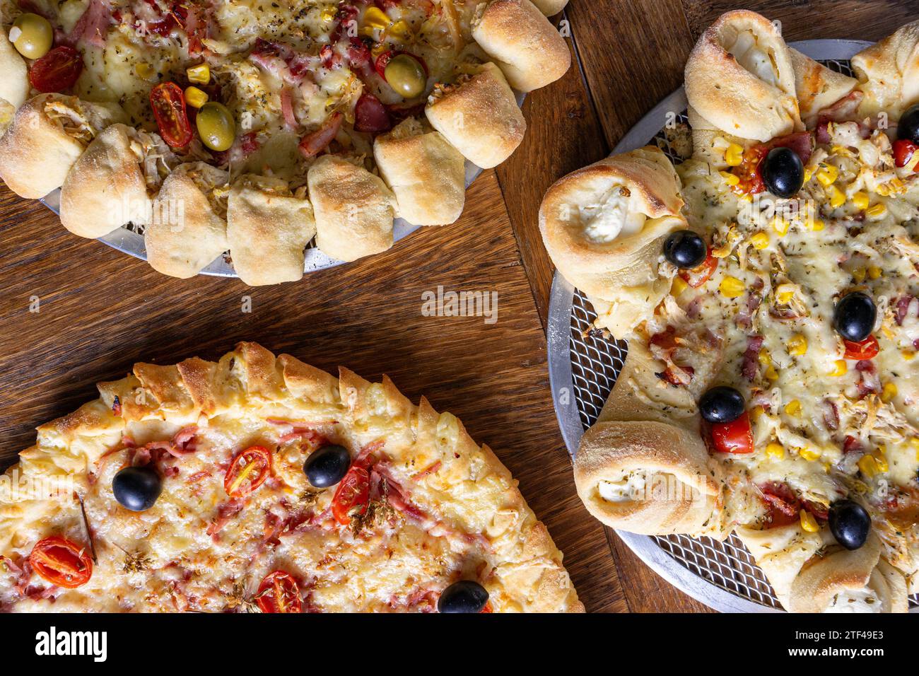 Delicious trio: classic pizza, volcano-style, and stuffed crust. Stock Photo