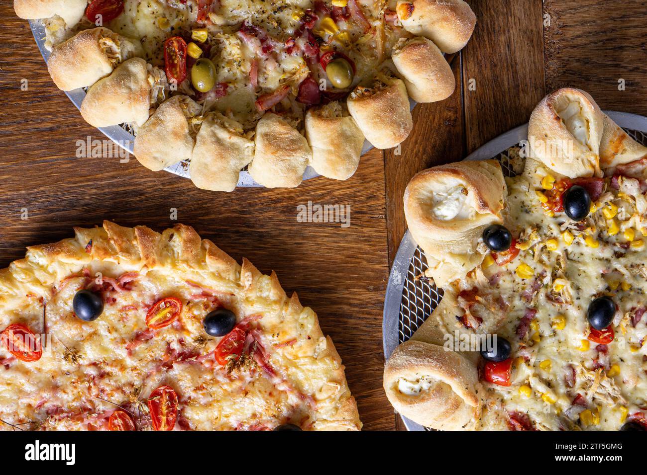 Delicious trio: classic pizza, volcano-style, and stuffed crust. Stock Photo