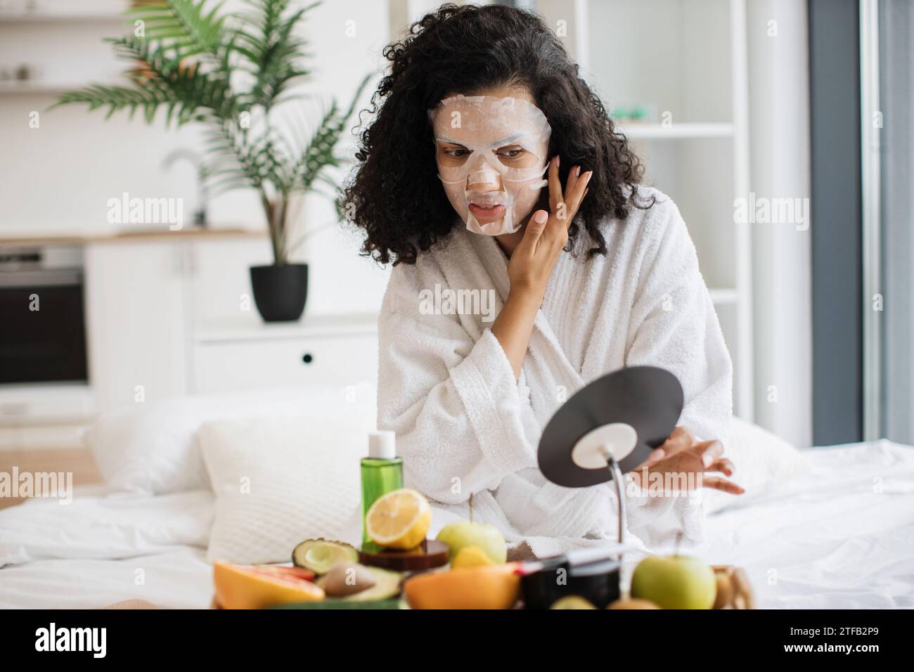 African woman putting face mask hi-res stock photography and images - Alamy