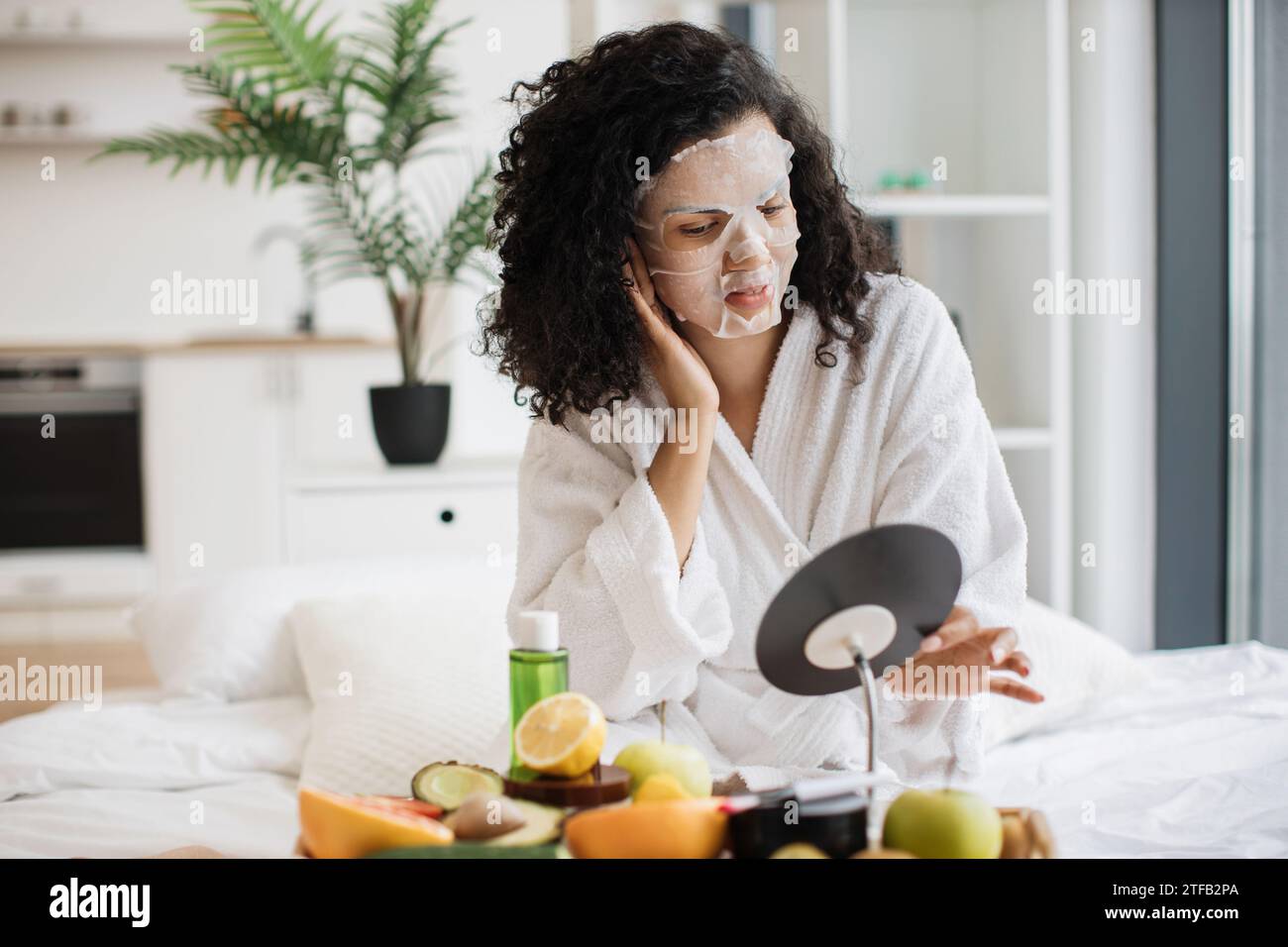 African woman putting face mask hi-res stock photography and images - Alamy